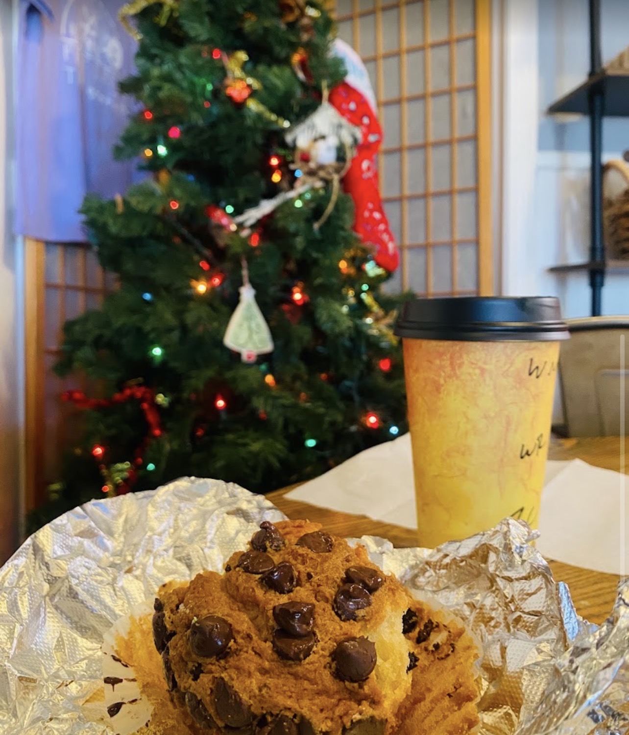 Warm coffee and chocolate chip muffin by our decorated Christmas tree